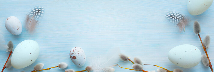 Art Happy Easter background; Easter eggs and spring flowers on blue table