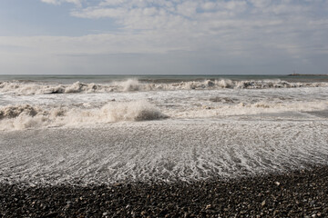 stormy sea waves crash on the shore