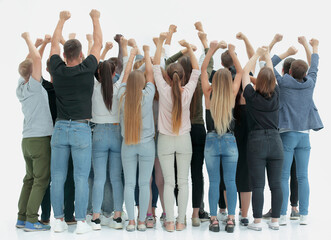 Fototapeta premium team of happy young people standing with hands up
