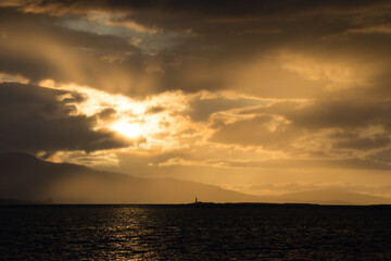 Dramatic Cloud Scape during Sunset - Oban Harbour, Argyll, Oban, Scotland - Moody silhouette image of sunset looking towards Lismore Lighthouse.