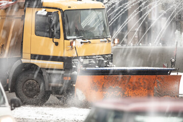 Snow plow truck cleaning streets from heavy snowfall.