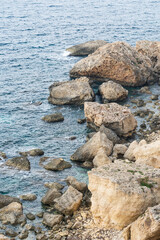Close up of rocks and blue waves at the shore of Manikata, Malta
