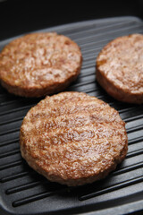 Tasty fried hamburger patties on grill pan, closeup