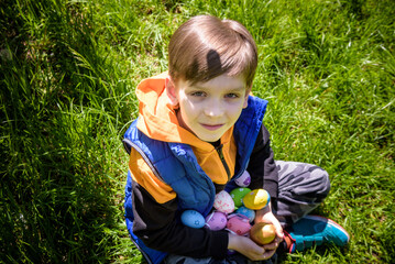 Different color Easter Eggs in a child's hands after egg hunt. T