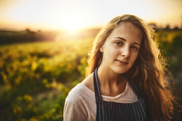 The farm life is for me. Portrait of a young woman working on a farm.