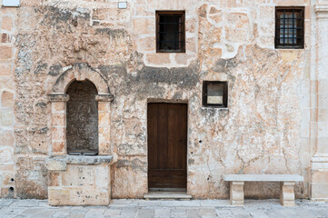 Fototapeta na wymiar Mellieha, Malta - 01 07 2022: Worn traditional facade of a residential house