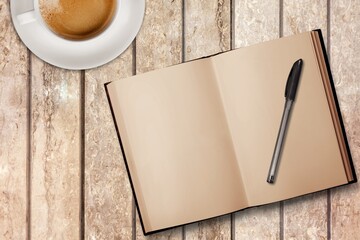 blank antique journal with paper pages with a stylish pen and cup of tea