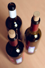 Three bottles of wine at home. Vertical photo.