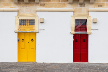 Marsaxlokk, Malta - 01 09 2022:  Two colorful doors of a facade near the port
