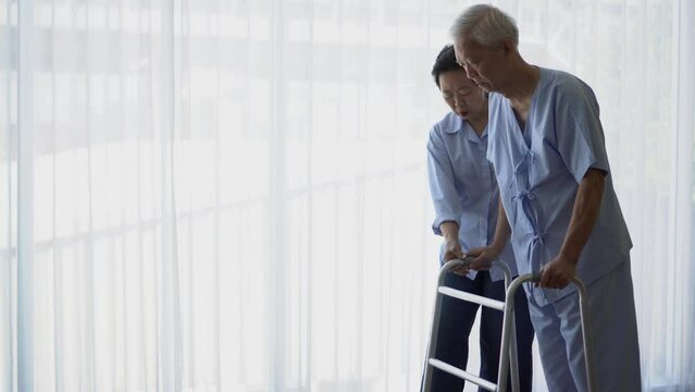 Asian senior elder man use walker to therapy try recovery from accident
