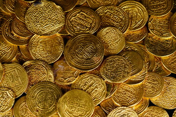 A pile of golden coins , saving money, business and financial concept. selective focus. Gold treasure. Ancient  coin. Golden money. rich government money. 
