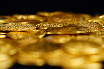 A pile of golden coins , saving money, business and financial concept . selective focus. Gold treasure