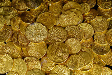 A pile of golden coins , saving money, business and financial concept. selective focus. Gold treasure. Ancient  coin. Golden money. rich government money. 