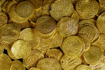 A pile of golden coins , saving money, business and financial concept. selective focus. Gold treasure. Ancient  coin. Golden money. rich government money. 