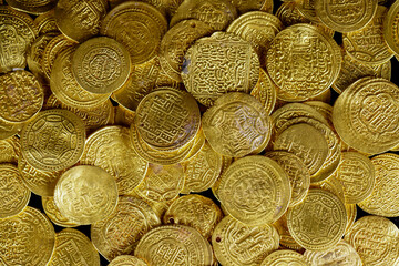 A pile of golden coins , saving money, business and financial concept. selective focus. Gold treasure. Ancient  coin. Golden money. rich government money. 