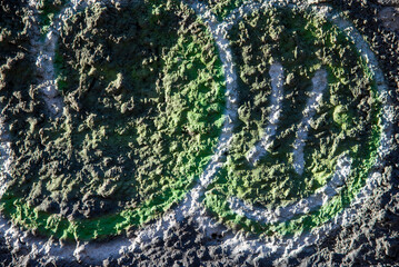 An old colorful concrete wall plastered with traces of old paint, texture.
