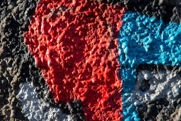 An old colorful concrete wall plastered with traces of old paint, texture.