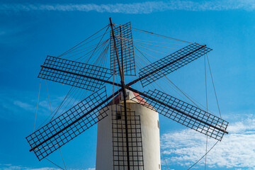 White windmill with blue sky background  in Menorca (Spain).