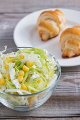 Salad with cheese croissant.