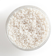 Uncooked arborio rice in glass bowl isolated on white background with clipping path