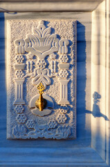 Scenic ancient bronze tap for drinking water on a beautiful decorated marble wall in Ankara, Turkey. Nice autumn day. Travel and tourism concept