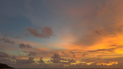 Fototapeta premium .aerial view stunning sunset above Pu island Kata beac Phuket Thailand. .Scene of colorful red light trough in the dark blue sky..Gradient color. Sky texture, abstract nature background.