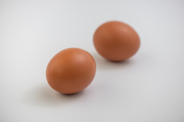 Closeup of fresh brown eggs over white background