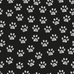 White doodle paw prints with black background seamless fabric design pattern and background