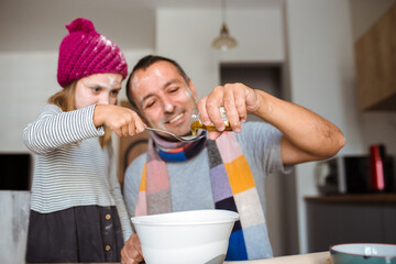Father and daughter cooking cookies at home. Winter concept.