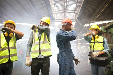 factory workers close the nose because there is a fire and smoke in machine factory