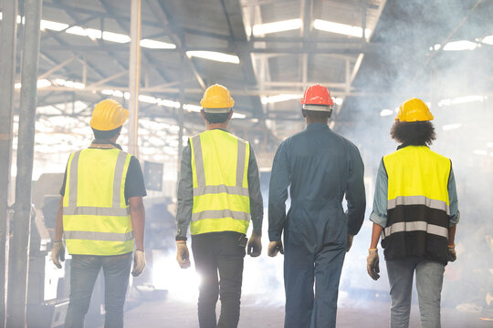 Back View Factory Workers And Technician Walking In Warehouse For Start A Work