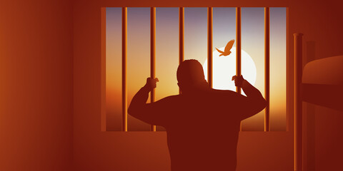 Concept du prisonnier enfermé dans sa cellule, qui regarde un oiseau s’envoler derrière les barreaux. - obrazy, fototapety, plakaty
