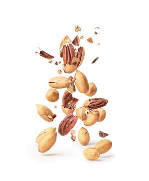 pecan nuts flying in the air on a white background