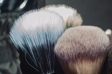 Makeup brushes on a black background, with a place to insert text,
