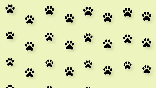 Colorful pattern of cat paws on yellow background. Seamless pattern with cat paw. Top view. Dog, cat footprint background. 4K video motion