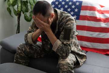 man in military uniform crying USA flag background.