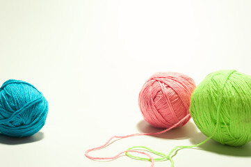 skeins of a colored yarn for needlework on the white background