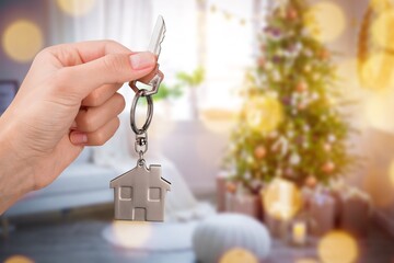 Hand with Key to the house. A gift for New Year, Christmas.  new house, rent and purchase real estate.