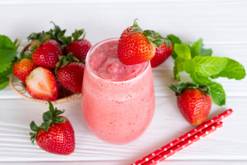 Strawberry yogurt fruit juice smoothie pink colorful fruit juice milkshake blend beverage healthy high protein the taste yummy In glass drink episode morning on white wood background.