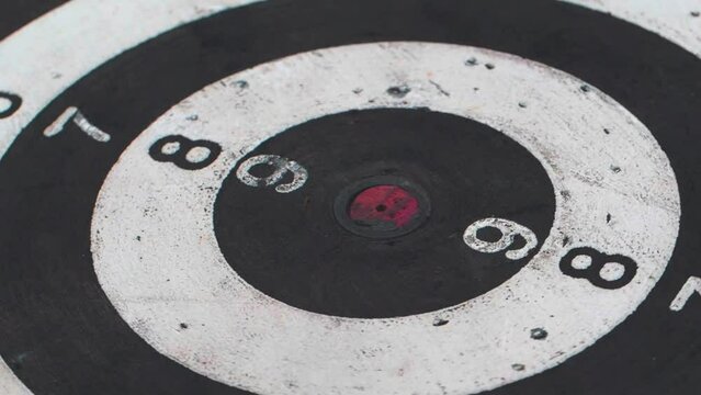 Darts are fired at a close-up and revolving circle target. The idea is that the darts are always moving.