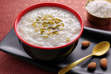 Sabudana Kheer thick pudding with tapioca pearls sago dessert from cassava root Indian sweet mithai  chowari payasam for Mahashivratri Ram Navami Diwali festival.