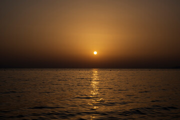 Tranquil scene of beautiful sea at sunset. Scenic seascape. Orange and yellow sunset on the sea. Aerial panoramic view of sunset over sea.