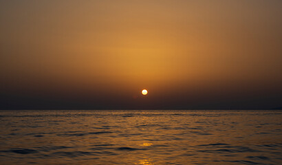 Tranquil scene of beautiful sea at sunset. Scenic seascape. Orange and yellow sunset on the sea. Aerial panoramic view of sunset over sea.