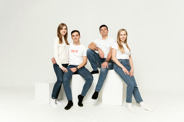 Obraz premium group of young people on a white background. brothers and sisters. company of friends in formal wear on a white background