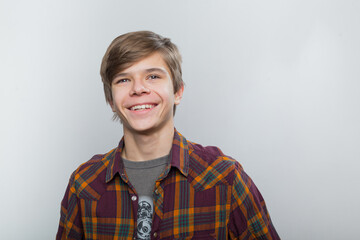 Emotional portrait of a teenager in a plaid shirt