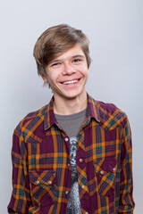 Emotional portrait of a teenager in a plaid shirt