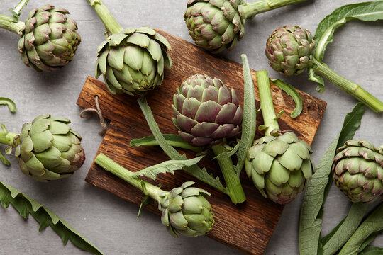 Fresh green artichokes cooking on wooden background