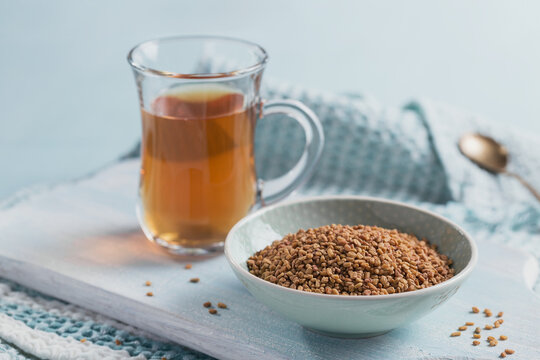 Bowl of fenugreek seeds and Egyptian fenugreek yellow tea or Methi Dana drink