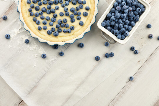Cooking blueberry pie or tart with fresh berries