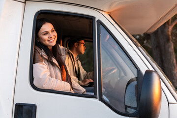 Active and handsome family traveling by the white car in the woods. Happy brunette girl looks at the views. Stock photo
